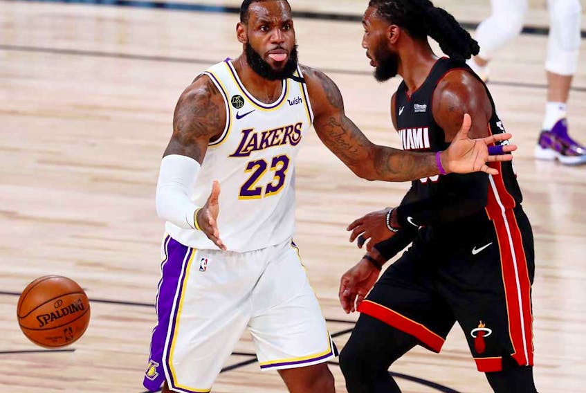 Los Angeles Lakers forward LeBron James, left, reacts after a call during the fourth quarter of Game 3 of the 2020 NBA Finals against the Miami Heat at AdventHealth Arena, in Orlando, Fla., Oct. 4, 2020.