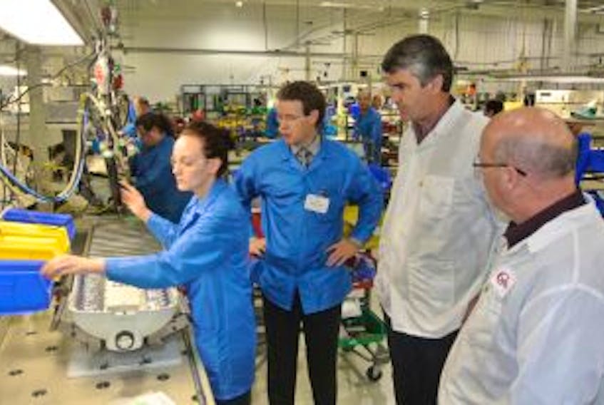 ['Liberal Premier Stephen McNeil and Cumberland North MLA Terry Farrell look over the assembly line at LED Roadway Lighting with company executive vice-president of operations Dave Scott during a campaign stop at the facility in October. The company announced this week it has begun recalling employees that were laid off in the fall.']