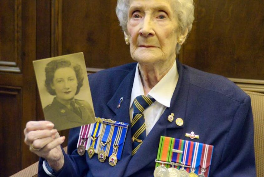 Joyce Paynter holds a photograph of herself as she looked when she served in the Canadian Womens Army Corps.