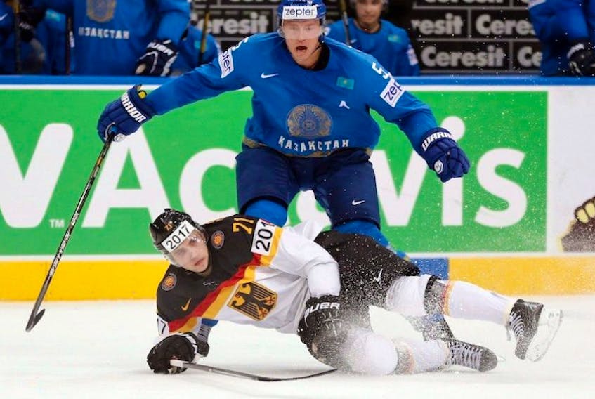 Germany forward Leon Draisaitl, bottom, is challenged by Kazakhstan defender Alexei Litvinenko during the Group B preliminary round match between Germany and Kazakhstan at the Ice Hockey World Championship in Minsk, Belarus, Saturday, May 10, 2014. NHL draft prospect Draisaitl wants to be an ambassador for German hockey.