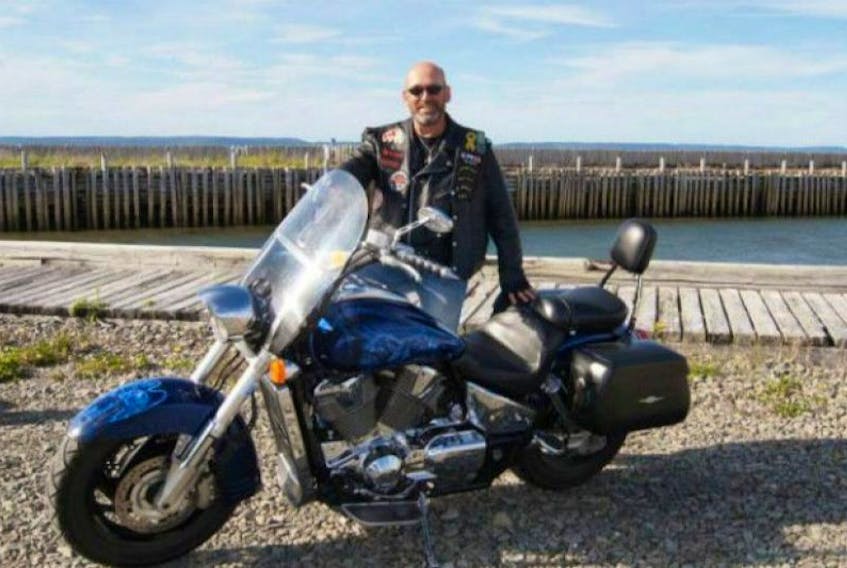 <span>Robin Lessard next to his stolen motorcycle. Submitted</span>