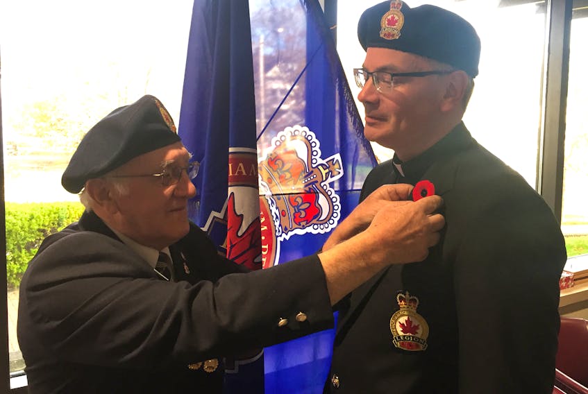 Royal Canadian Legion Arras Branch 59 poppy campaign chair J.P. MacEachern (left) pins the first flower of the 2019 campaign on branch chaplain Reverend Peter Smith. Corey LeBlanc