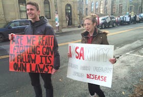 Aquaculture can be a divisive issue. On Dec. 14, 2017, two opposing protests took place in St. John’s over the Grieg Aquaculture project. Brendan Kelly and Katie Kennedy were calling for an environmental assessment of the Grieg Aquaculture project in St. Lawrence. In the background, on the other side of the street, residents of the Burin Peninsula demonstrated in favour of the project, saying it was important for the local economy and they were satisfied with the steps taken by the province and company to ensure environmental safety. — Telegram file photo