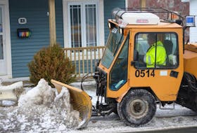 In this file photo, a City of St. John’s snowclearing crew member clears and salts a section of sidewalk on Empire Avenue. TELEGRAM FILE PHOTO
