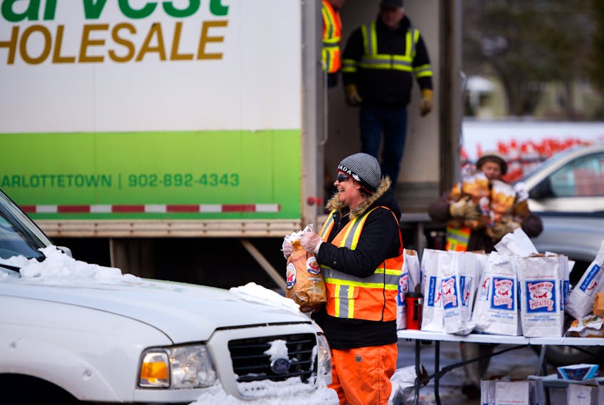 Cars line up by Victoria Park in Charlottetown to receive free care packages made up of dairy products and potatoes in this April 11 photo. Nathan Rochford/The Guardian
