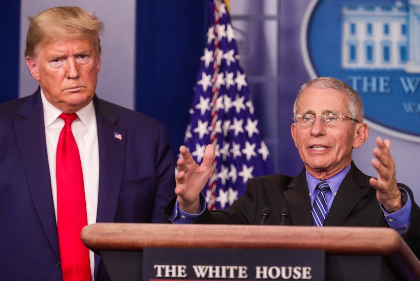 U.S. President Donald Trump listens as Dr. Anthony Fauci, director of the National Institute of Allergy and Infectious Diseases, addresses the coronavirus task force daily briefing at the White House in Washington, D.C., Wednesday. — Reuters/Jonathan Ernst