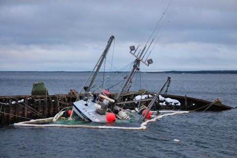 A boat that sank off the wharf in Embree on Dec. 25 is scheduled to be removed from the water tomorrow..