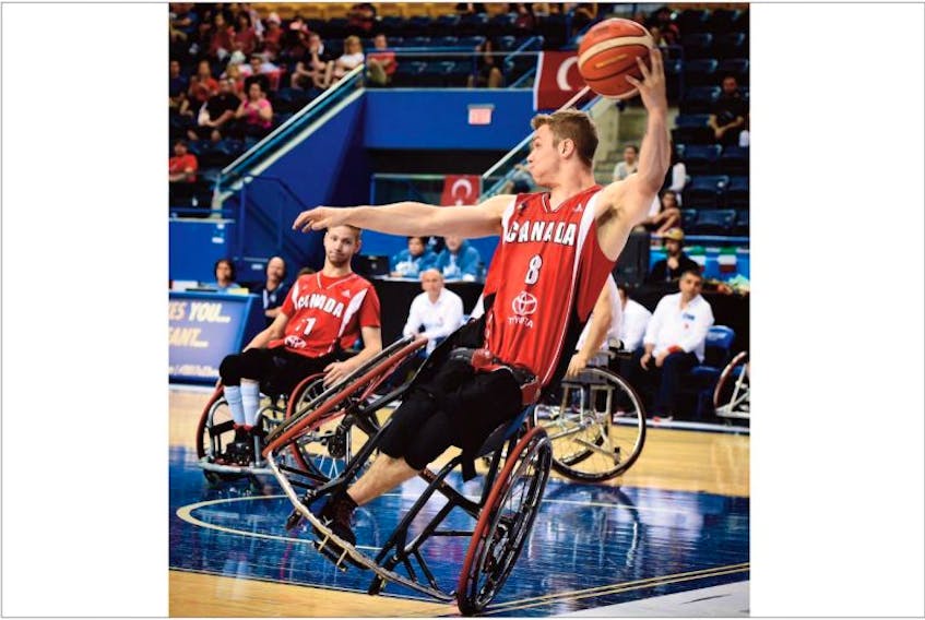 
Canada’s Liam Hickey is on one wheel as he keeps a ball inbounds during a round-robin game against Brazil at the world men’s under-23 basketball championship in Toronto Monday night. 