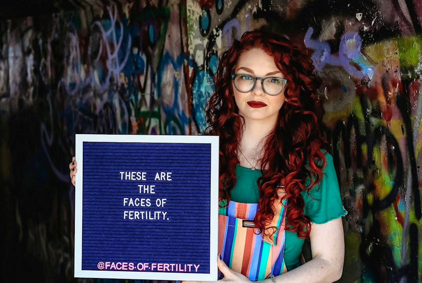 Ledon Wellon of Mount Pearl poses with a sign as part of an awareness campaign she launched last year on her Facebook page Faces of Fertility.