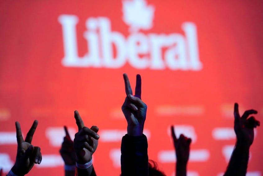  Liberal Party supporters flash V-signs while watching the live federal election results at the Palais des Congres in Montreal, Quebec, Canada October 21, 2019