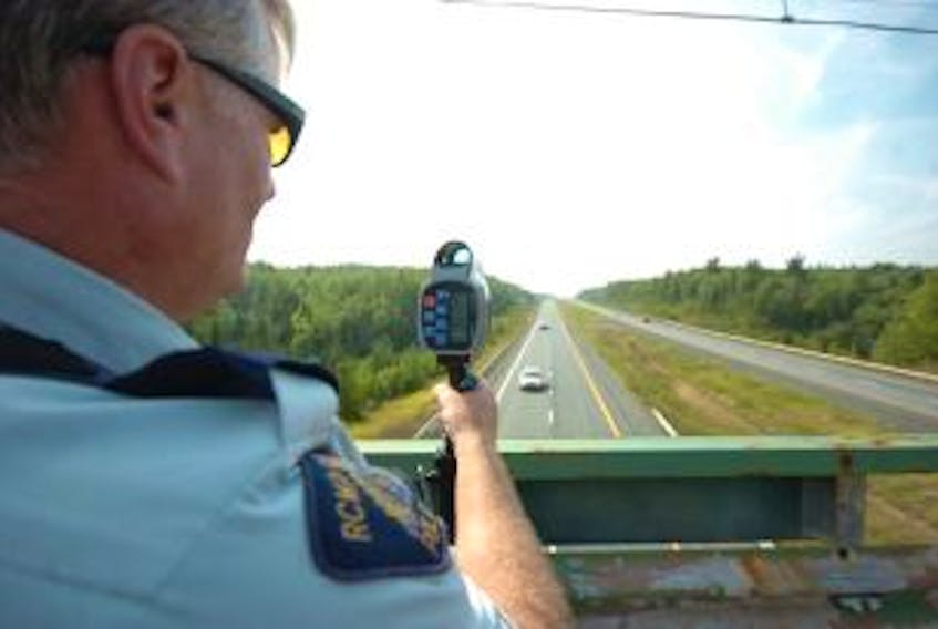 ["Cpl. Darren Galley watches motorists on the Trans Canada Highway with the Cumberland District RCMP's new Speed Laser. The Northern Traffic Services section of the RCMP has been stopping speeding motorists on the highway since receiving the laser gun two weeks ago. Raissa Tetanish - Amherst Daily News"]