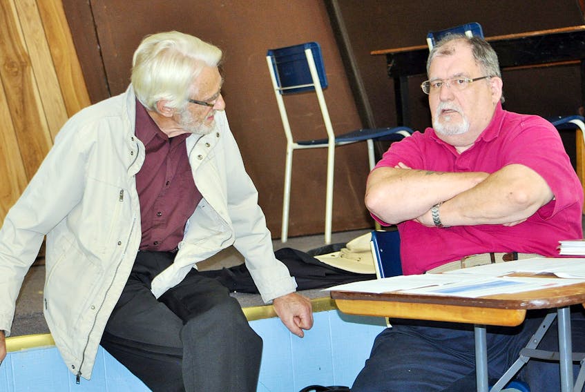 Parrsboro Lighthouse Society outgoing treasurer Alain Couture (right) has a discussion with Kerwin Davison during a break at the annual general meeting at the Parrsboro legion on Wednesday, Oct. 11.