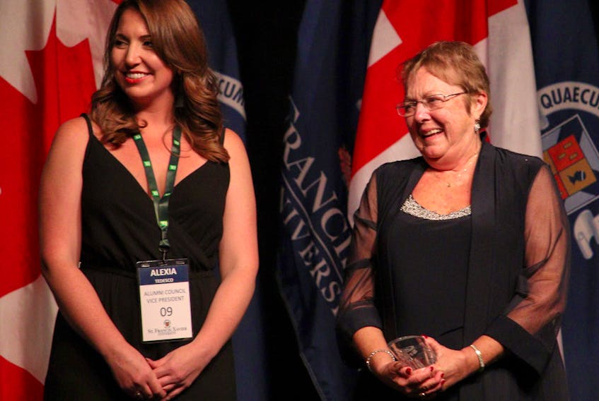 Linda MacDonald (right) stands by St. F.X. Alumni Association vice president Alexia Tedesco prior to receiving the inaugural Xaverian Spirit Award during Homecoming 2019. Contributed
