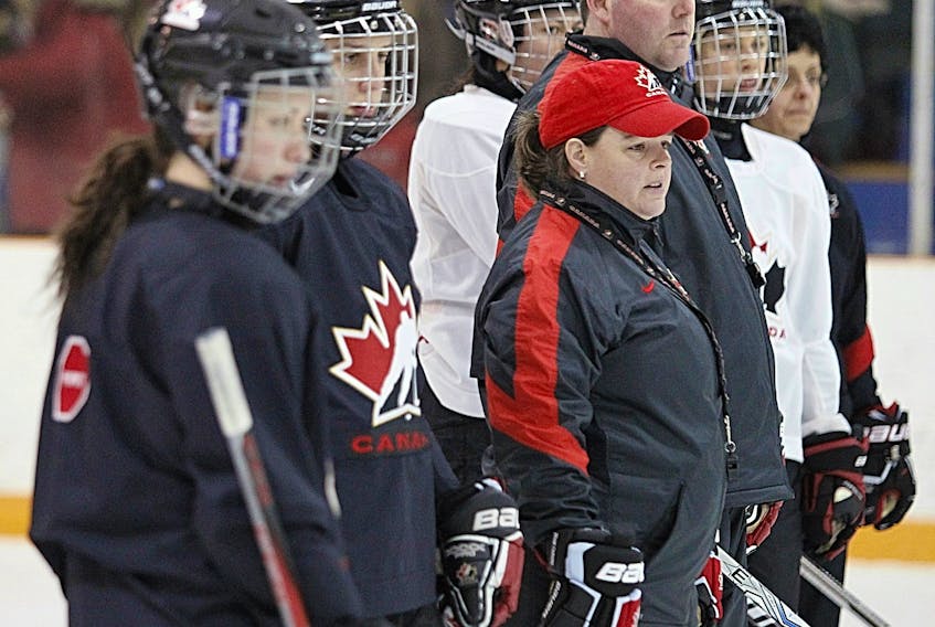 Lisa Haley, middle, shown during her tenure with Hockey Canada,  has been named the head coach of the Hungarian women’s hockey team. POSTMEDIA