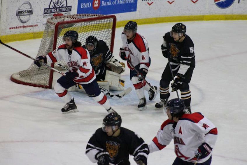 Brett Thompson, left, was around the Dalhousie net a lot during Acadia's 5-1 victory over the Tigers Nov. 26 in Wolfville. Thompson ended up with three goals and an assist, raising his league-leading goals total to 12 and league-leading points total to 24. The Axemen moved into a first-place tie with UNB with their fifth straight win.