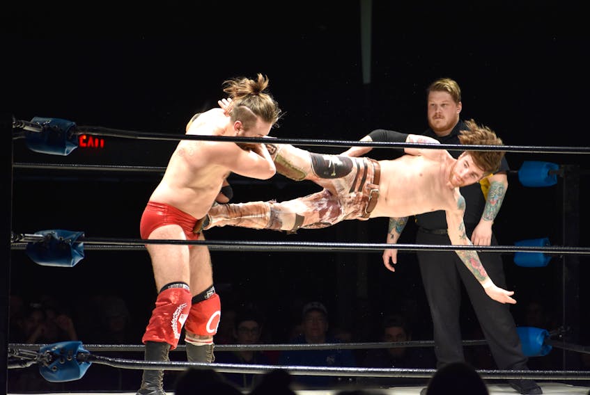 Chip Chambers, right, delivers a kick to the head of Covey Christ during live wrestling at Centre 200 in Sydney on Monday. Covey Christ, whose real name is Ryan Covey, is originally from Sydney and is the co-owner of Kaizen Pro Wrestling based out of Halifax. More than 200 people attended the free show, which was part of the Cape Breton Regional Municipality’s Taste of Winter Festival.  JEREMY FRASER/CAPE BRETON POST