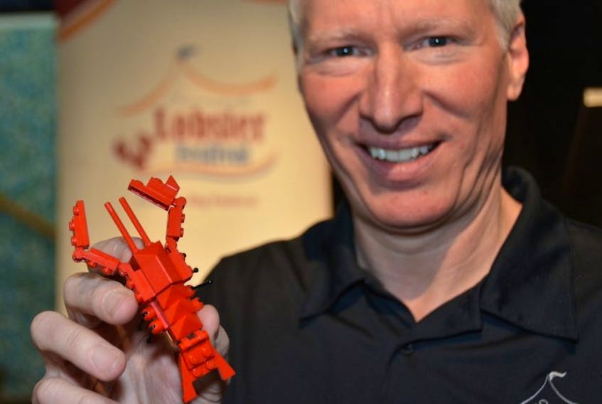 <p>Don Quarles, Lobster Festival executive director, shows off a LEGO lobster, made up of more than 50 pieces of the blocks. LEGO lobster kits will be among the events and activities on offer during July’s Summerside Lobster Festival.&nbsp;</p>