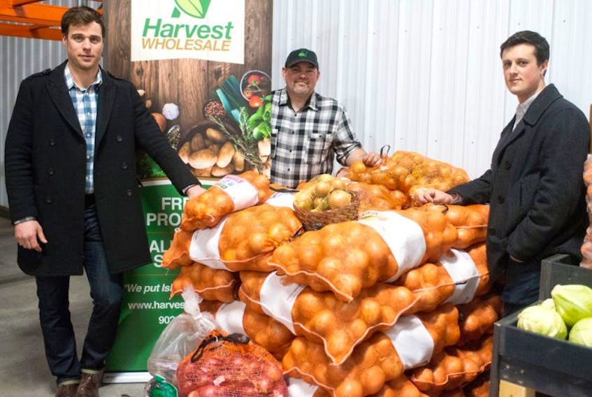 <p><span class="BodyText">Josh Patterson, left, Harvest’s operations manager; Mike Murphy, warehouse manager and Evan Murphy, sales and some of the local produce on display during the recent grand opening of the warehouse facility in Charlottetown.</span></p>
