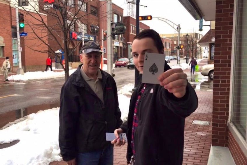 <p>Logan McLellan, right, took to the streets with a coworker recently to help spread some Christmas cheer. They rigged a game of Chase the Ace so they could give away a total of $1,000 to several unsuspecting shoppers in Summerside, like Nelson Blanchard, shortly before the holidays.&nbsp;</p>