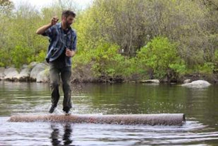 ['Darren Hudson shows off his logrolling skills. The world champion lumberjack is aiming to give people the real lumberjack experience whether it’s logrolling or axe throwing.']