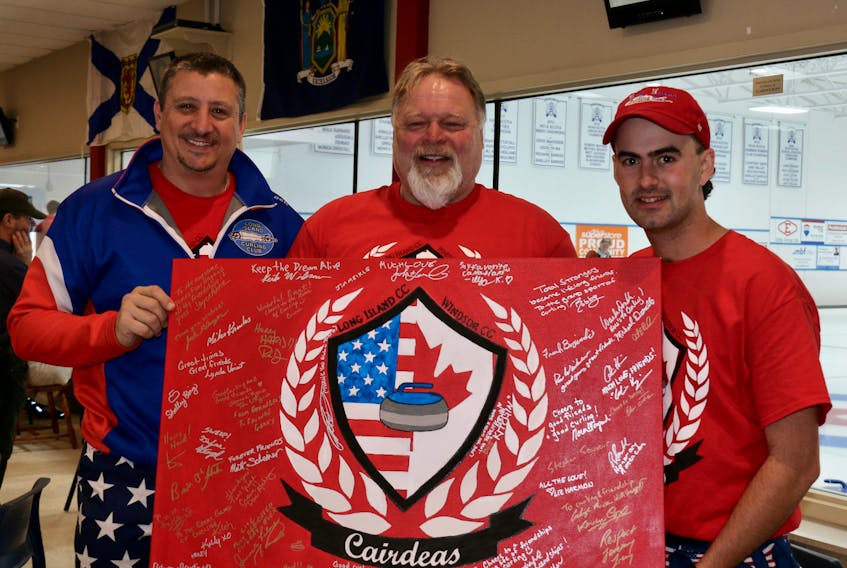 Bobby Iadanza, the president of the Long Island Curling Club, and curler John Lusardi, right, show Rick Kitchin, of the Windsor Curling Club, a hand-painted token of their appreciation. The signed item will hang at the curling club as a symbol of their friendship.
CAROLE MORRIS-UNDERHILL
