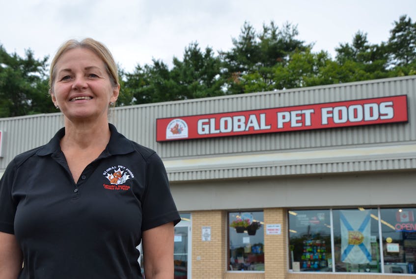 Jane Payne, owner of the New Minas Global Pet Foods store, loves it when customers bring their pets in for a visit. KIRK STARRATT