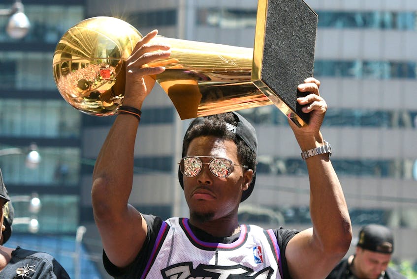 Raptors guard Kyle Lowry shows off the Larry O'Brien trophy to fans during a parade through downtown Toronto last summer to celebrate their NBA title. (Dan Hamilton/USA TODAY Sports)