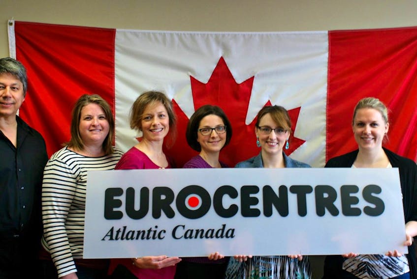 
Alden Darville (left) and Nicola Sattler (right) pose with current and former staff in a marketing photo for Eurocentres Atlantic Canada. Contributed 

