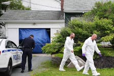 Members of the Halifax regional police forensic identification service walk toward a Lynwood Drive home in Dartmouth on Sunday, July 12, 2020. Police were at the residence for a second straight day in a continuing investigation into the suspicious death of an 85-year-old woman.