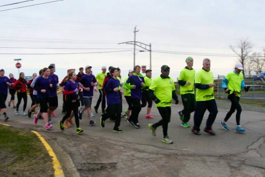 Runners head to the Westville Municipal building during the M.O.R.E. event.