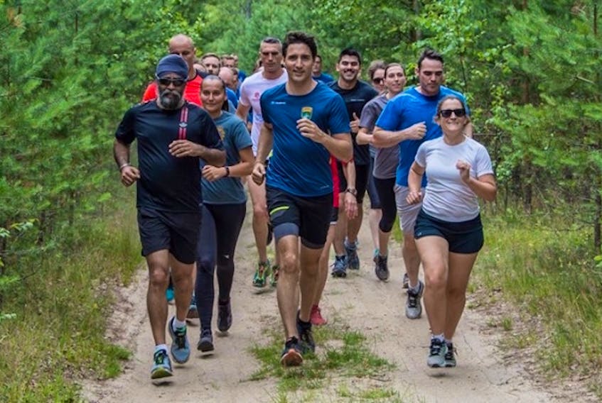 Maj. Chris MacAdam of Morell, second row at right, (in blue T-shirt) was part of the Canadian military security detail who were assigned to protect Prime Minister Justin Trudeau during his visit to Latvia last week. The assignment included a jog with the PM and defence minister Harjit Sajjan. MacAdam is on a six-month assignment to Latvia.
(Submitted photo)