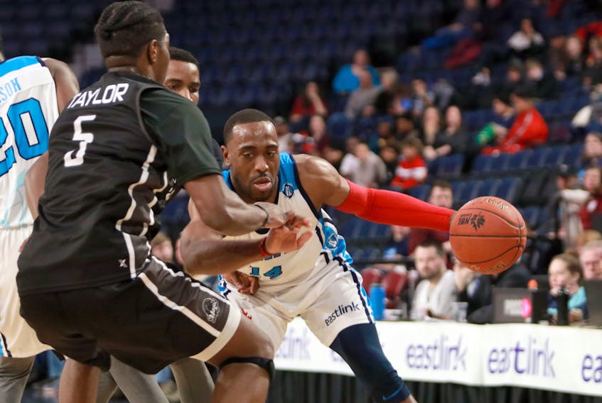 Halifax Hurricanes’ Antoine Mason, right,  tries to get around Moncton Magic’s Denzell Taylor during NBL of Canada action on  Sunday.
ERIC WYNNE/Chronicle Herald