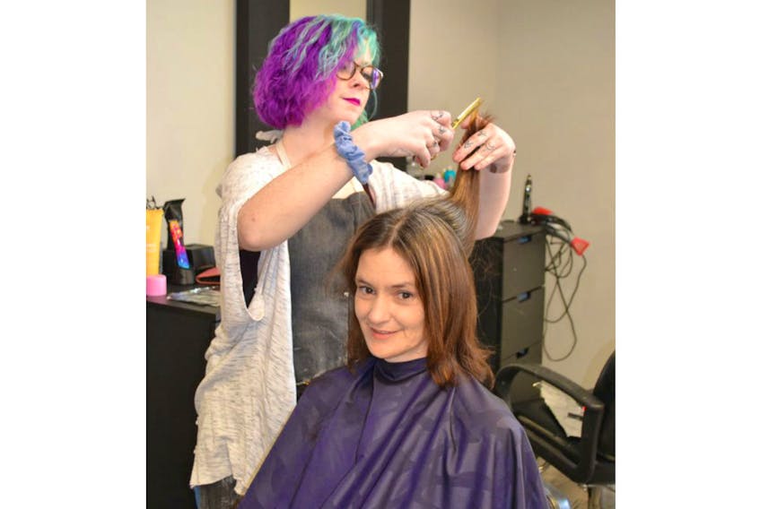 Angela Weir, a contestant in Extreme Makeover Tangerine Edition, has her hair cut by stylist Caleigh Aitken, at Tangerine Hair & Spa in Charlottetown. She’s one of the 13 people who will be featured during the reveal party today.