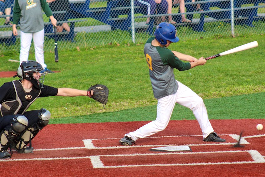 Kant Keagan of the Memorial Marauders, right, drives a ball into the ground as catcher Parker Crosby of the Breton Education Centre Bears watches during Nova Scotia School Athletic Federation Highland Region baseball regional tournament action at Susan McEachern Memorial Ballpark in Sydney on Tuesday. The score result was not provided to the Cape Breton Post upon request. Action continues today with Memorial hosting Glace Bay at 4 p.m. at Brown Street Ball Field in Sydney Mines. JEREMY FRASER/CAPE BRETON POST.
