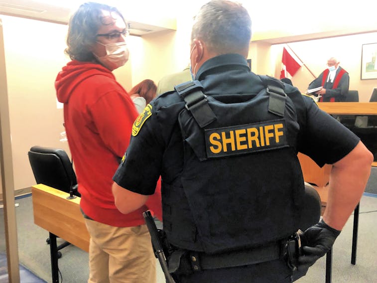 A sheriff reaches for his handcuffs in provincial court in St. John's Wednesday, before placing them on convicted child lurer Kyle Brown, 31, and escorting him from the courtroom to the cells. Brown was sentenced to a year behind bars for sending sexually explicit messages and a photo to someone he believed was a 15-year-old girl. The "girl" was actually a male RNC officer with a covert identity.