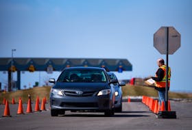 Cars wait in line in March at the Covid-19 checkpoint at the Confederation Bridge in Borden-Carleton. Nathan Rochford/The Guardian