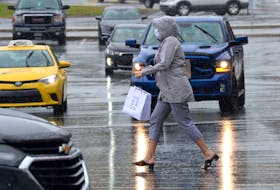A masked shopper makes her way across a mall parking lot recently. With customers required to wear face masks because of the COVID-19 pandemic, concerns are being raised about identification. Keith Gosse file photo/The Telegram