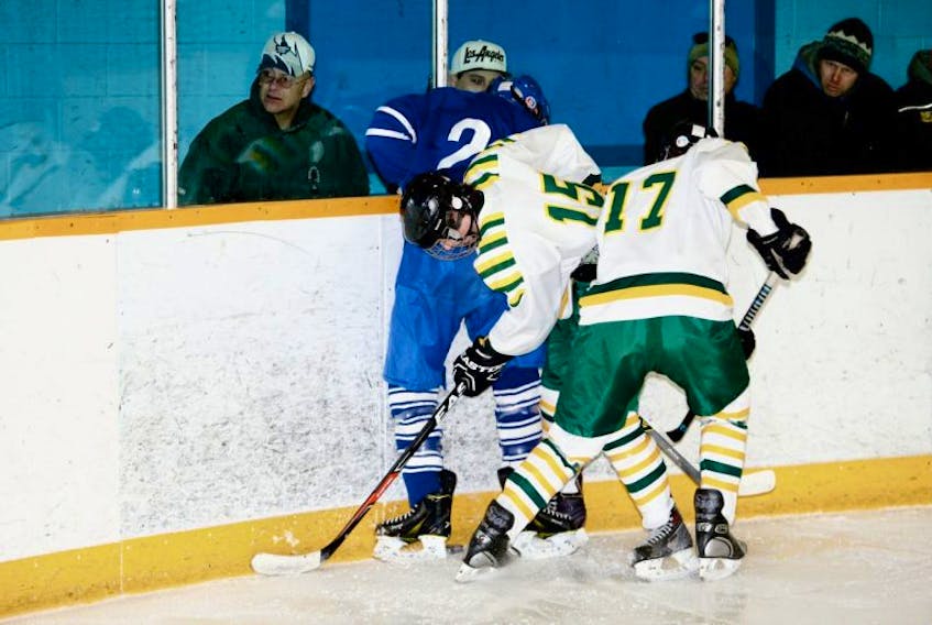 <p>The Mariners’ Noah Titus, number 15, and Ryan Connell try to dig the puck out from a Bridgetown defender in a game earlier this year.</p>