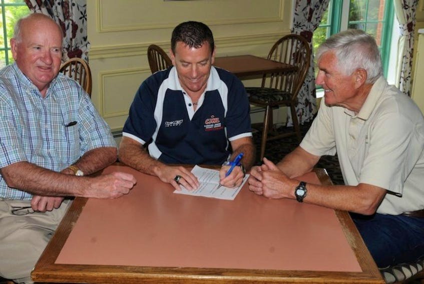 Maritime Junior Hockey League president and Kinkora native Derryl Smith, centre, chats with vice-president Cecil Taylor, right, of Charlottetown and Stu Rath of Truro, N.S., following the league’s annual general meeting in Summerside on Friday morning.