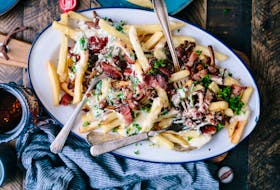 Mark DeWolf claims bacon makes just about everything better, including poutine. Photo: Brooke Lark
