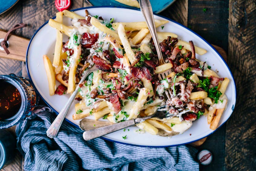 Mark DeWolf claims bacon makes just about everything better, including poutine. Photo: Brooke Lark