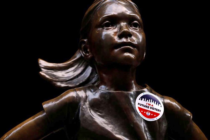 "I'm a Future Voter" sticker is seen on the Fearless Girl statue on Election Day outside the New York Stock Exchange. North American indexes surged following Tuesday’s vote.
