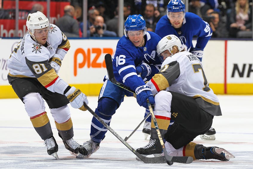 Golden Knights' Jonathan Marchessault and William Karlsson battle against Maple Leafs' Mitch Marner  on Thursday night at Scotiabank Arena in Toronto. (GETTY IMAGES)