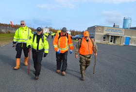 Sgt. Geoff MacLeod, left, of the forensic identification unit of the Cape Breton Regional Police Service,  heads back towards the woods surrounding the Glace Bay and Area Water Treatment Plant during a massive search by police in that area Monday morning. With MacLeod, from left, Const. Robert Stewart, Sgt. Mike O'Rourke with the forensic identification unit and Sgt. Barry Morrison, street crime unit. Police say the search was part of an ongoing investigation but couldn't confirm if they were looking for a person or evidence. Sharon Montgomery-Dupe/Cape Breton Post