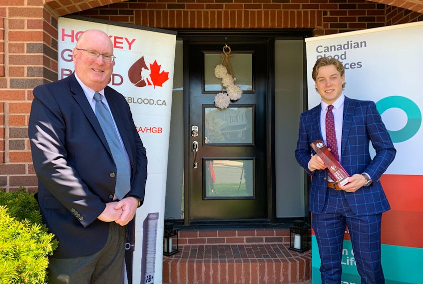 Peter MacDonald, left, director of donor relations for Canadian Blood Services in Atlantic Canada and Ontario, presented the Dayna Brons Honorary Award to Charlottetown Islanders’ goalie Matthew Welsh Wednesday in Halifax.