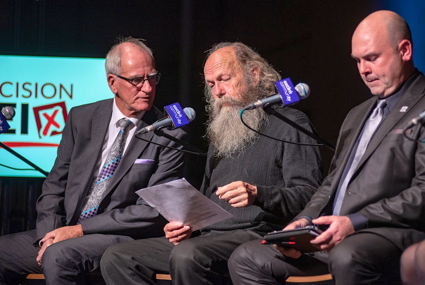 Candidates for the mayoralty of Charlottetown, Cecil Villard, left, Bill McFadden and Jamie Larkin, take a break during The Guardian's Mayor's Debate at UPEI Wednesday night. -Brian McInnis/Special to The Guardian