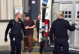 Peter Guy Joseph Monteith is led to a sheriff’s van Monday after appearing in Dartmouth provincial court on bank robbery charges Nov. 4, 2019.
