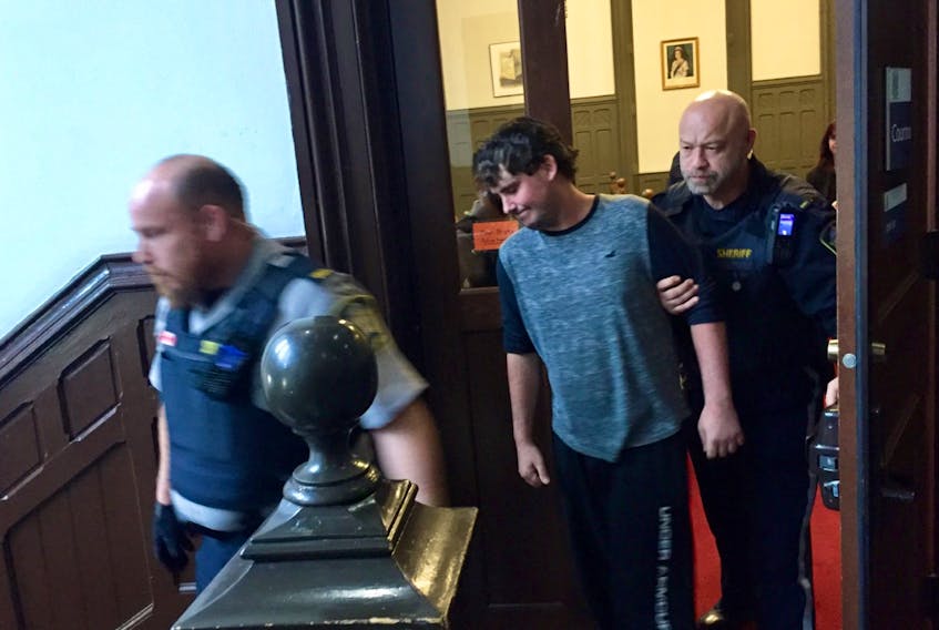 Jesse Arthur Simpson, 29, of Clark’s Harbour is led out of court Friday, Nov. 8, 2019, after getting bail on manslaughter and other charges in relation to the overdose death of a Halifax university student in November 2018.