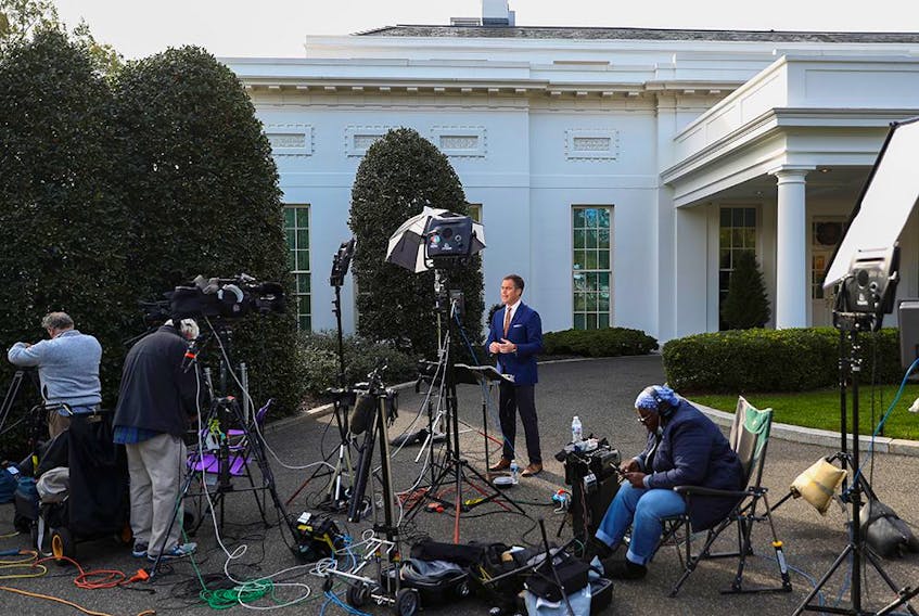  Members of the media are seen in front of the White House early in the morning on Nov. 6, 2020, three days after the inconclusive presidential election.