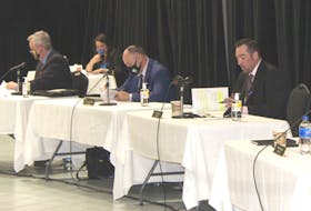CBRM councillors Steve Gillespie, left, and Eldon MacDonald listen as Glenn Paruch delivers an amended motion on Tuesday night regarding a proposal for a medical clinic to operate at 46 Cottage Rd. — IAN NATHANSON/CAPE BRETON POST